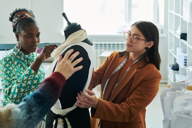 Two team members demonstrating embroidery